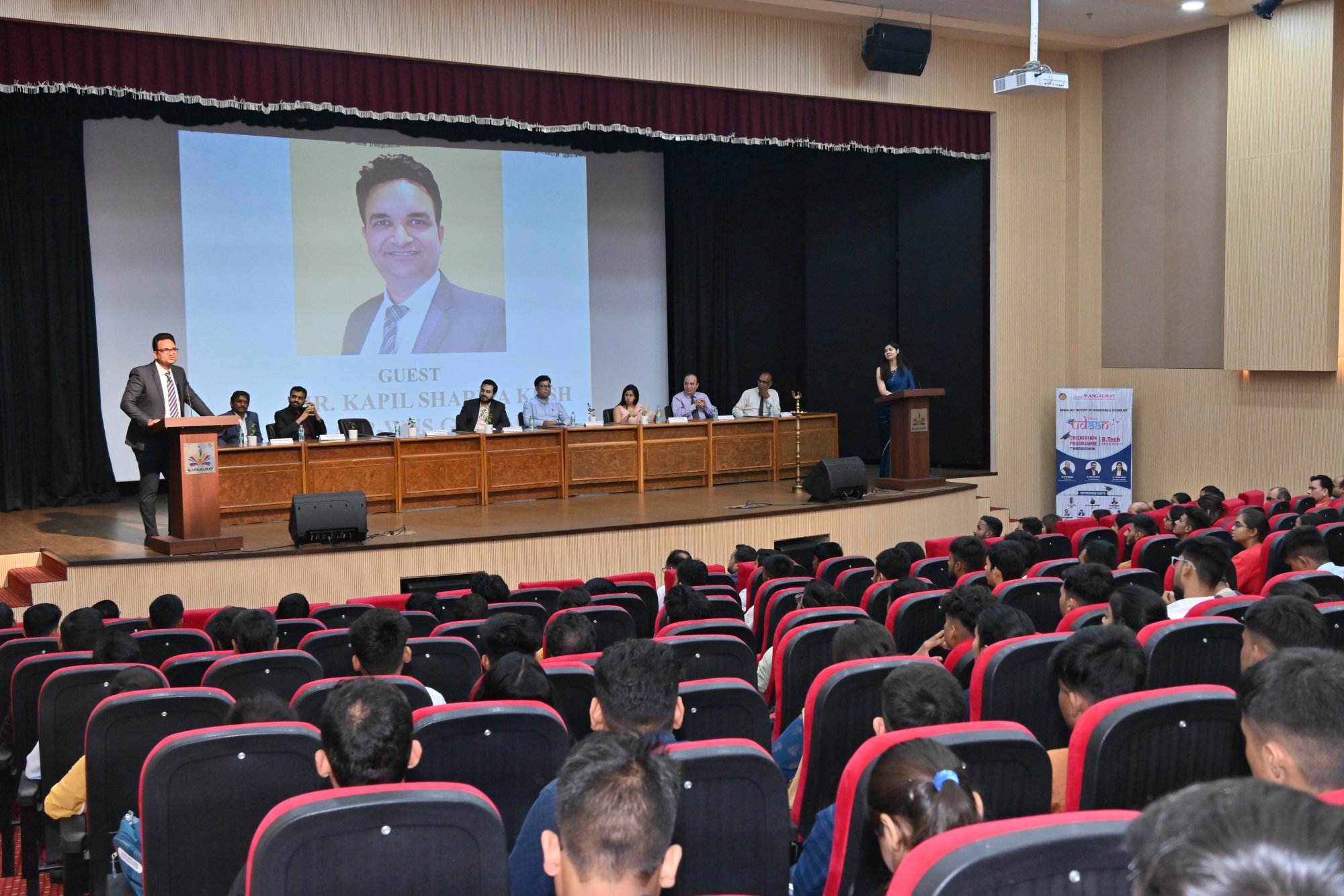 Kapil Sharma Kush speaking at a packed auditorium